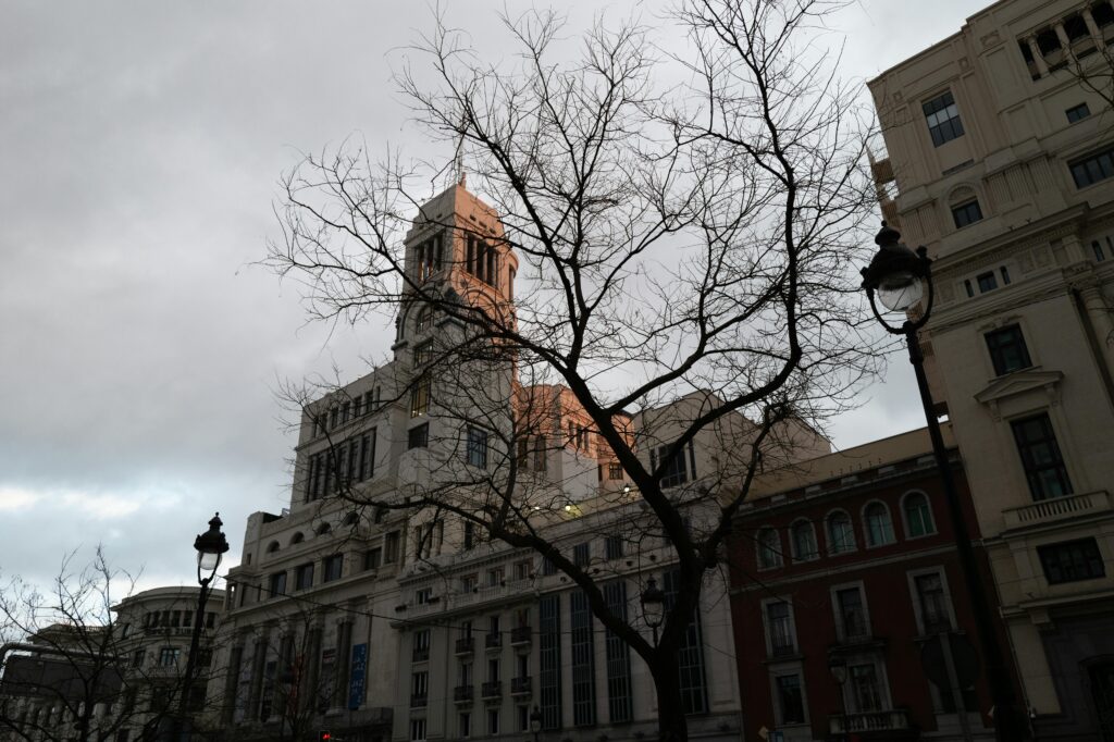 Dramatic skyline with historical architecture in Madrid during sunset.